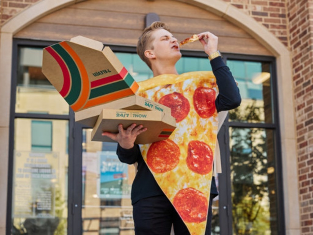 man eating pizza while wearing a pizza costume