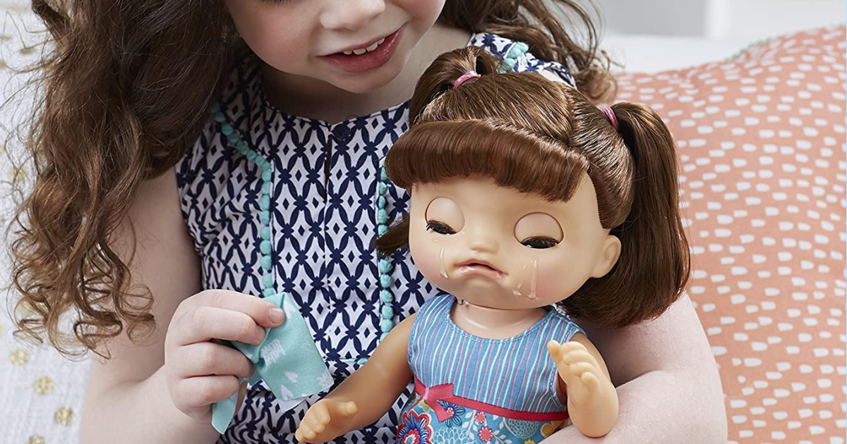 girl holding a doll that really cries