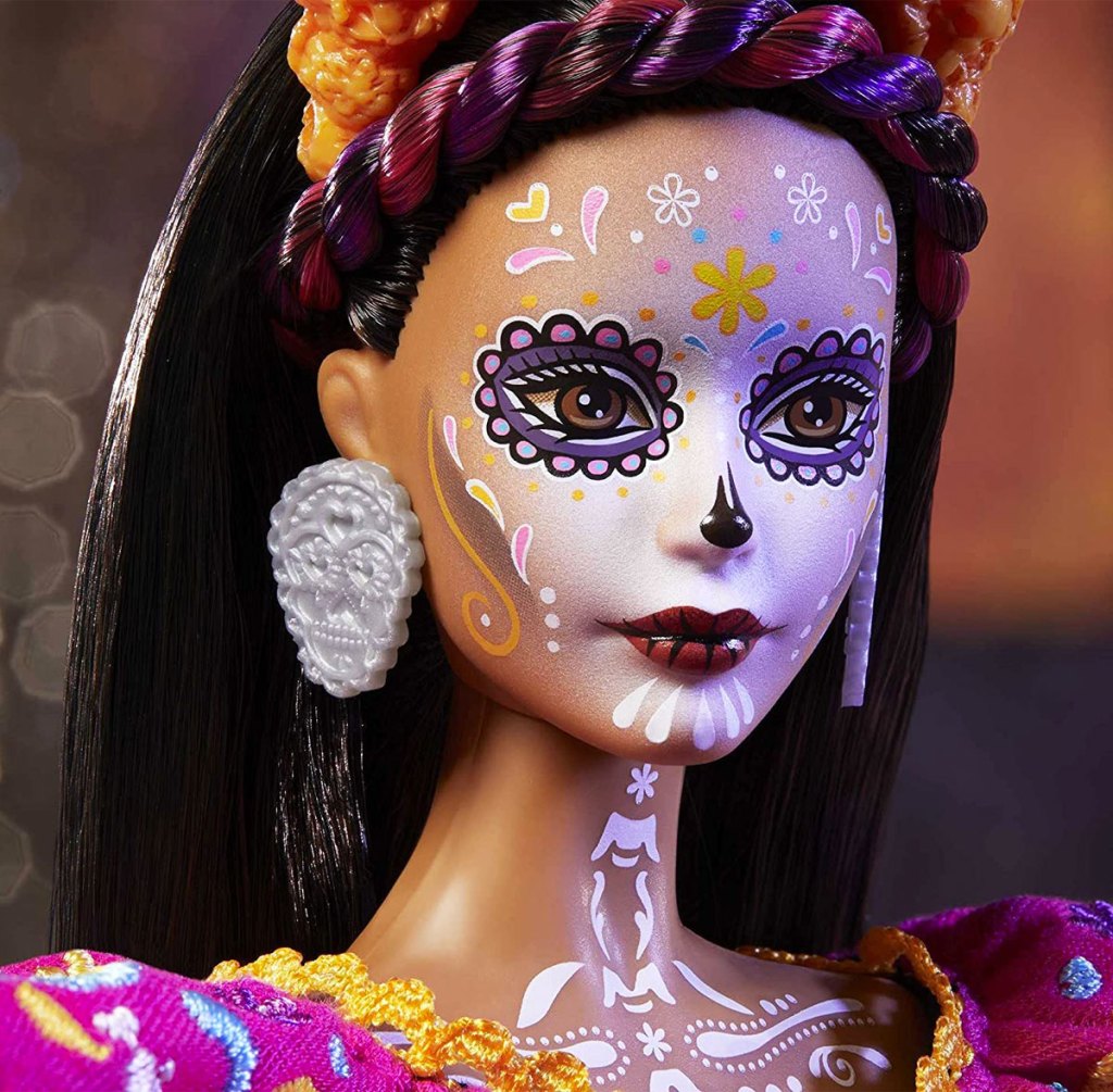 barbie doll with dia de muertos paintings on face and neck