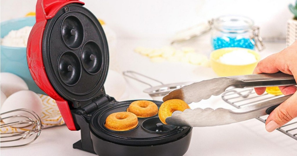 bella mini donut baker with tongs pulling off donut