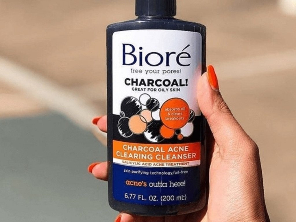 hand holding biore charcoal acne cleanser