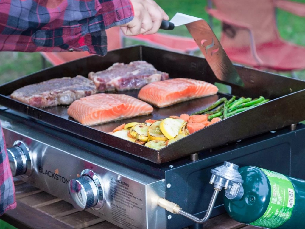 food cooking on a blackstone tabletop 2-burner grill