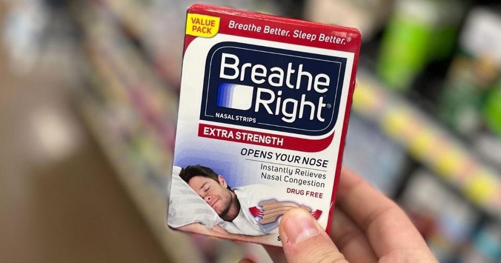 hand holding a box of Breathe Right Extra Strength Strips