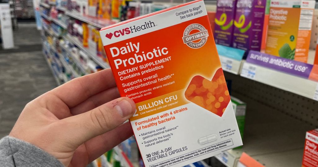hand holding orange box of probiotics 