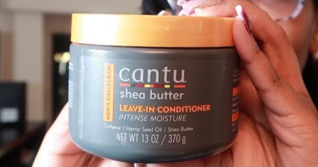 hand holding men's cantu leave in conditioner