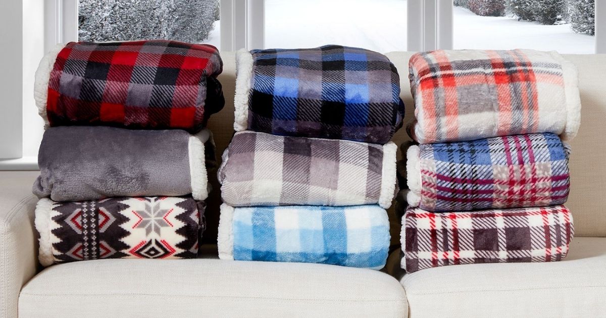 plush throws folded and stacked on sofa