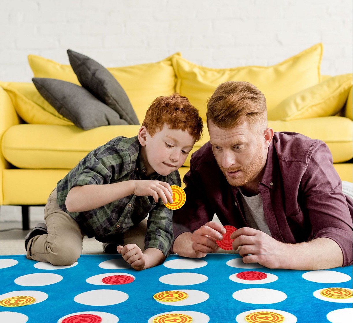 father and son playing Connect 4 Blanket Game
