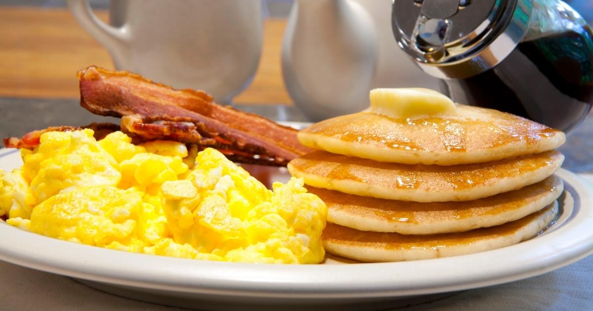 denny's breakfast plate with eggs, pancakes, and bacon