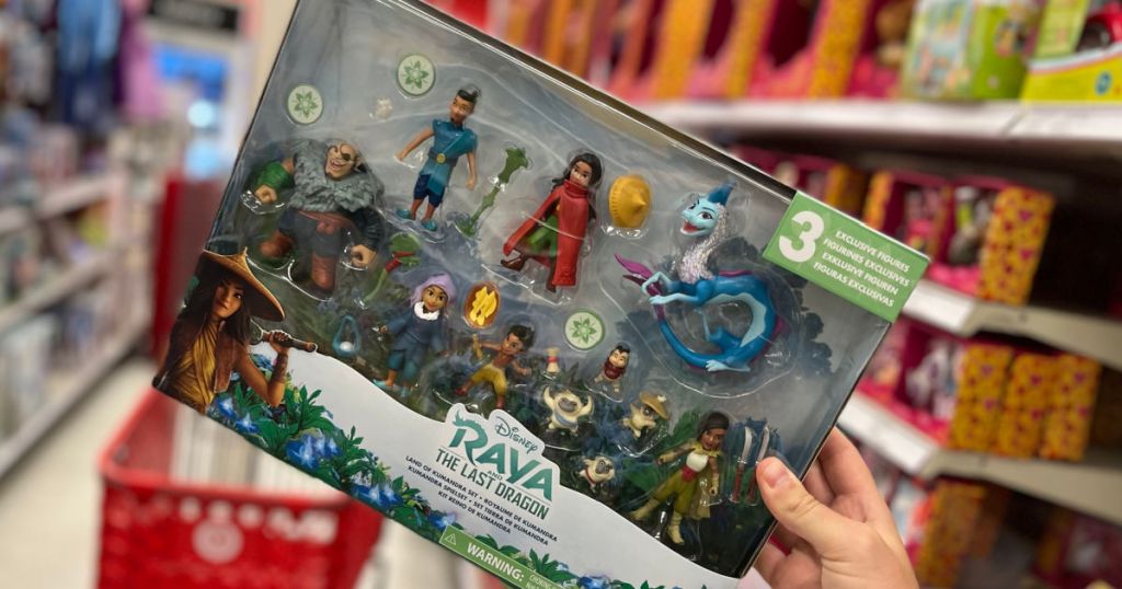 hand holding action figures in box