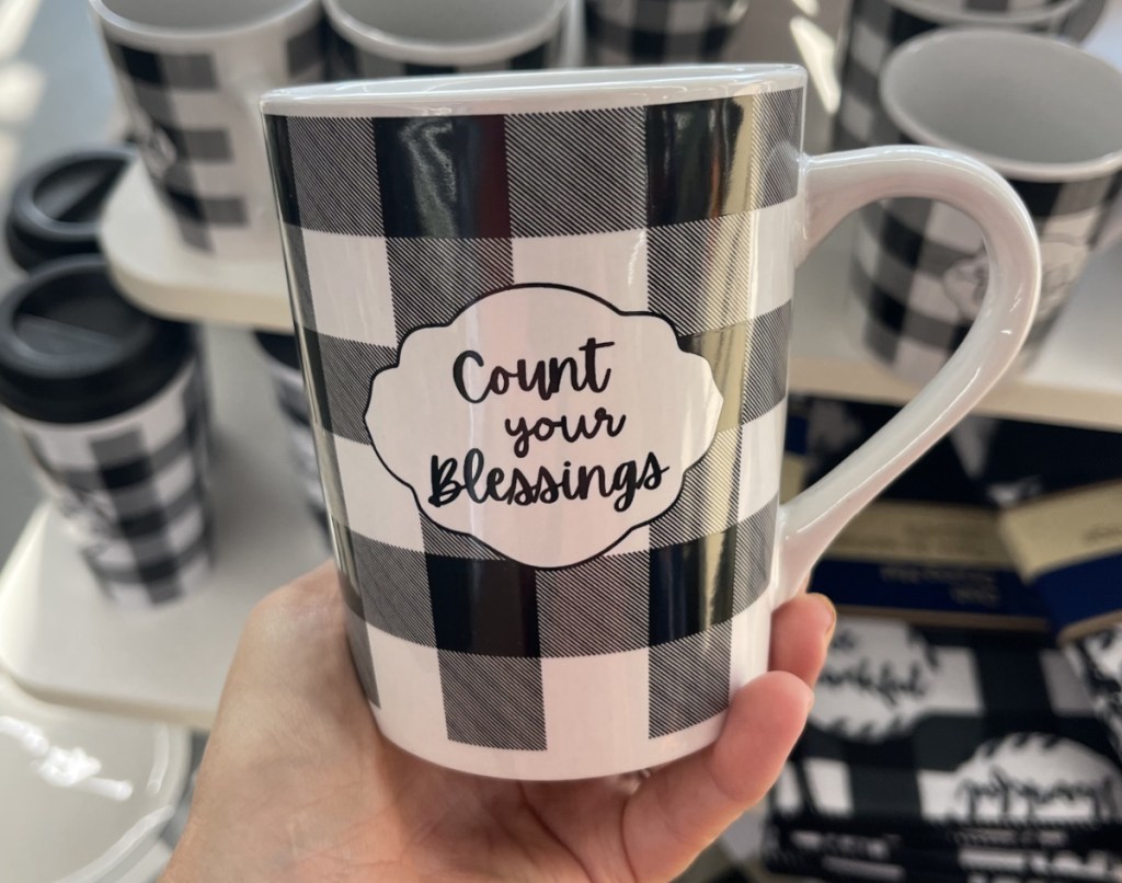 fall themed mug in hand near in-store display
