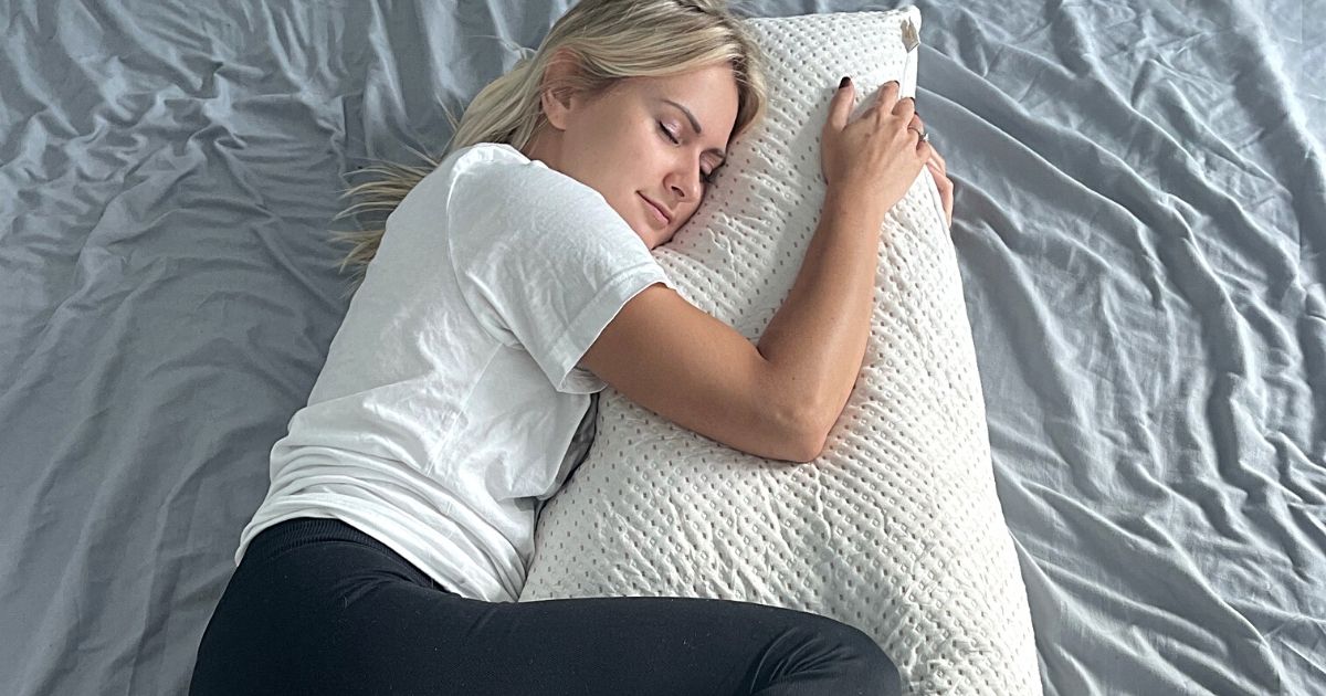 woman hugging body pillow