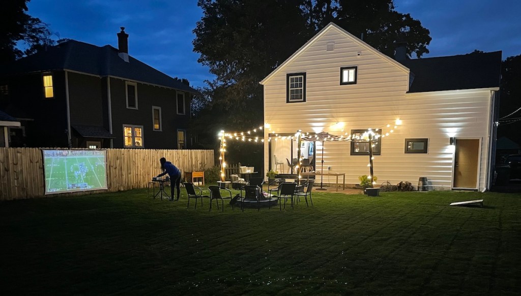 picture of backyard in the dark with projector and lights