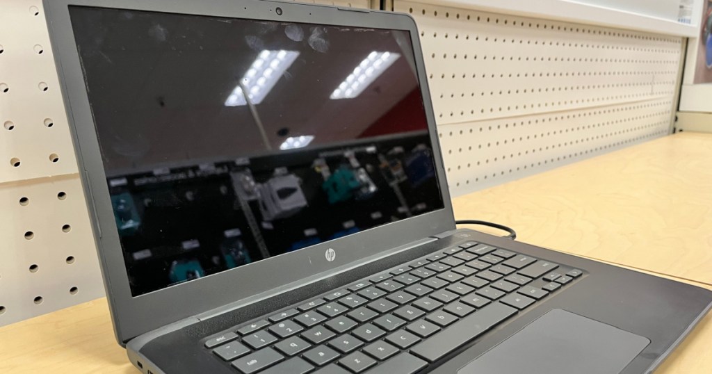 black laptop on shelf 