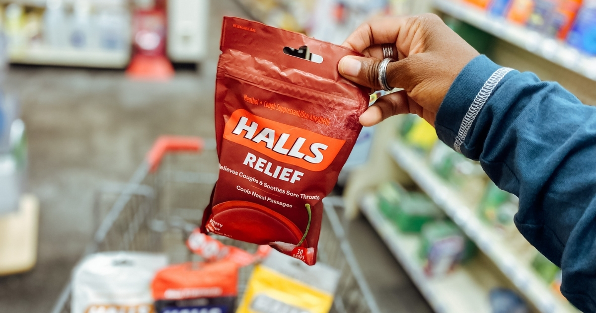 hand holding halls relief cough drops in store