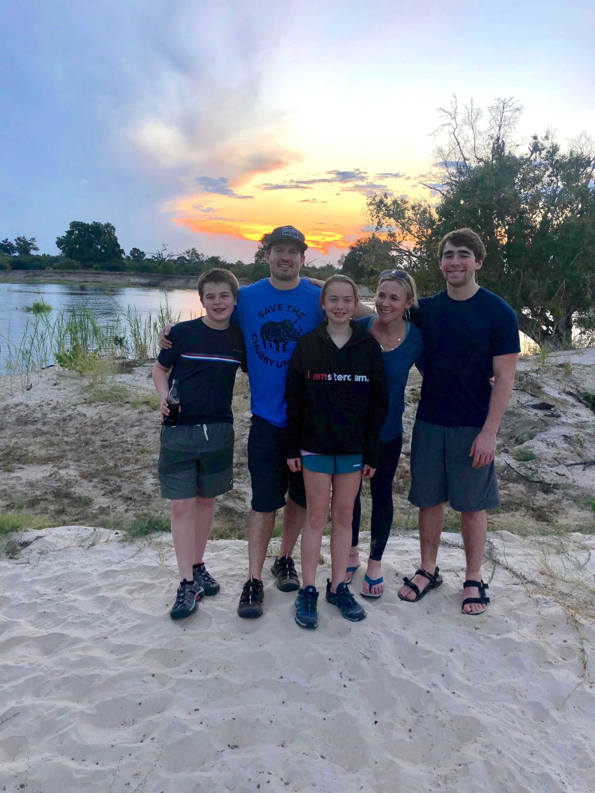 family together in front of sunset 