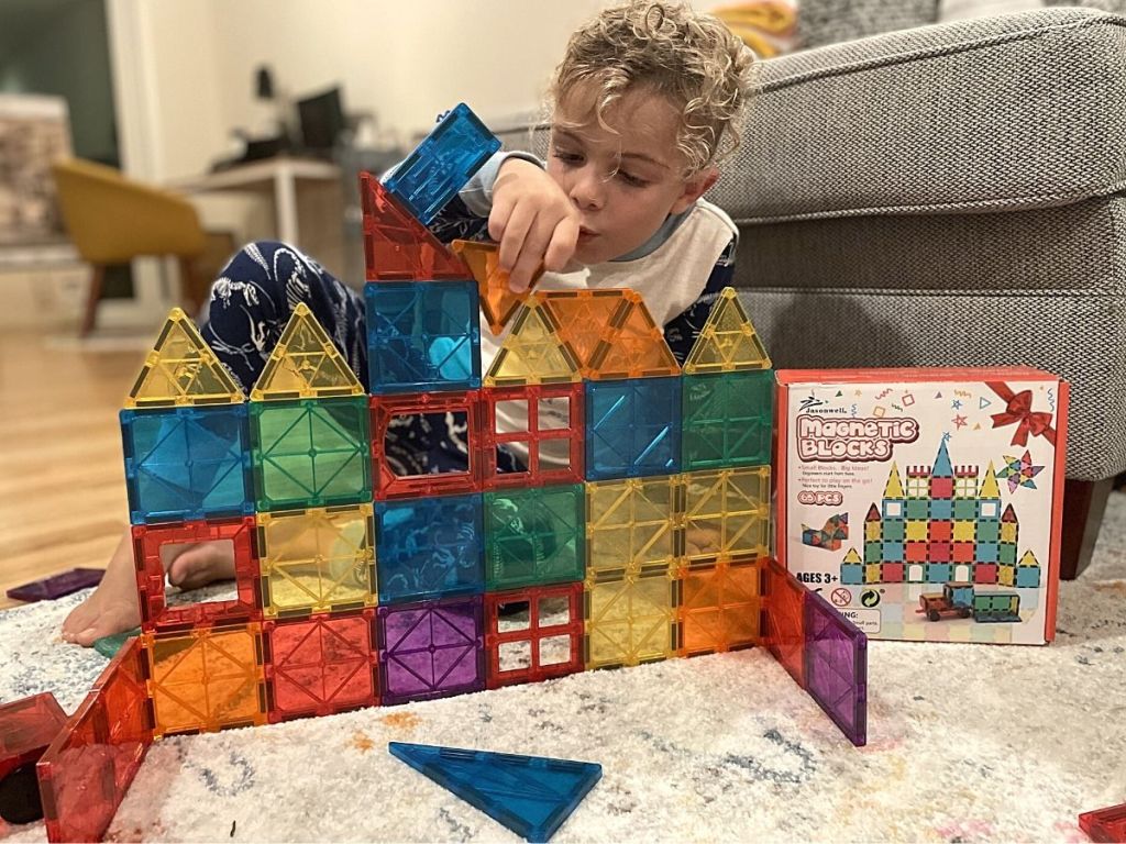 boy building with magnetic tiles 