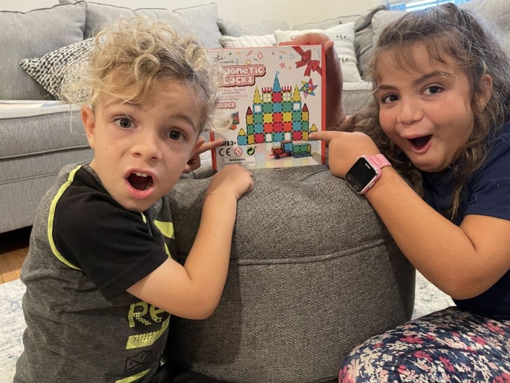 boy and girl pointing at Magnetic Tiles box