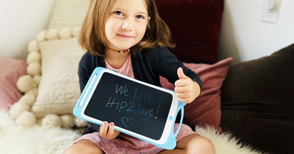 girl holding up doodle board