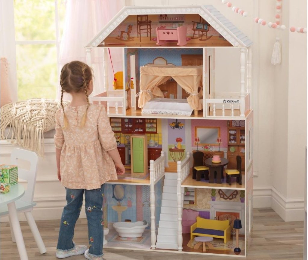 girl with kidkraft savannah wooden dollhouse