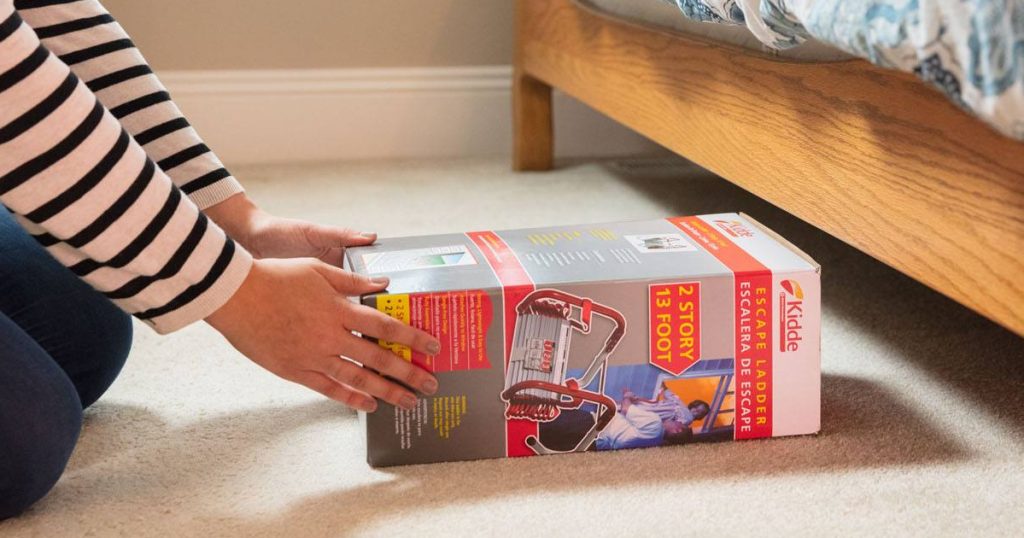 person putting an escape ladder under a bed