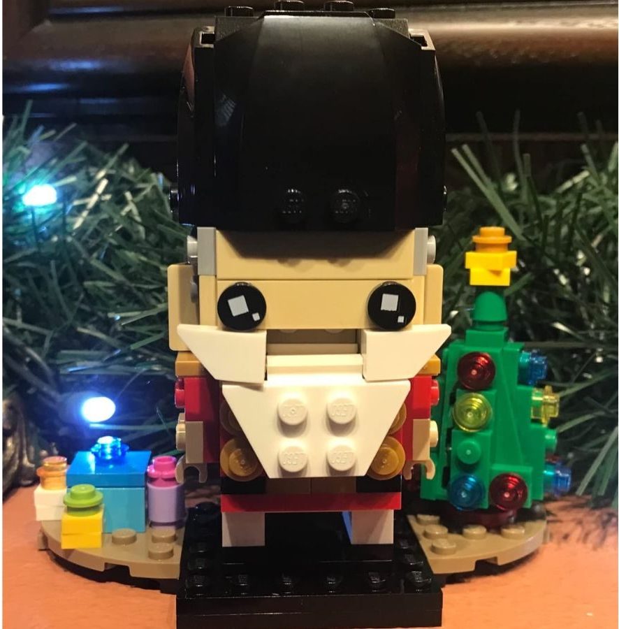 LEGO Brickheadz Nutcracker assembled in front of some Christmas greenery and lights