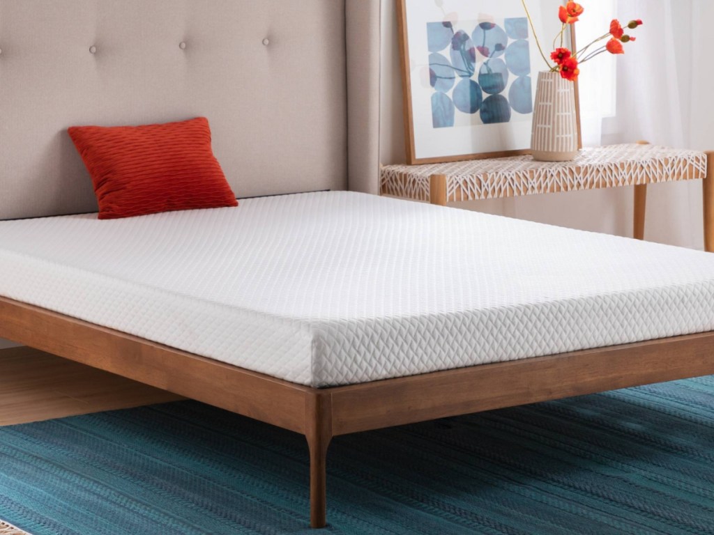 mattress on bed frame in bedroom