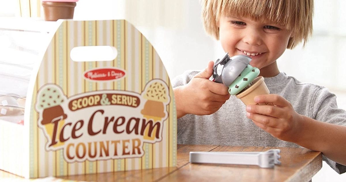 boy playing with a MElissa &amp; Doug Ice Cream Counter