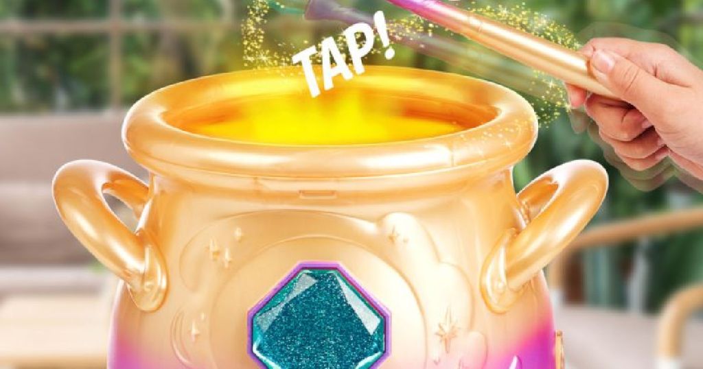 hand tapping toy gold cauldron