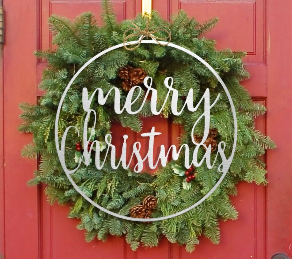 metal merry christmas sign on wreath