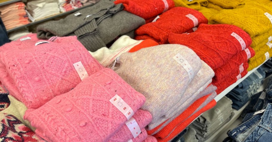 Old Navy Sweaters folded on table in multiple colors