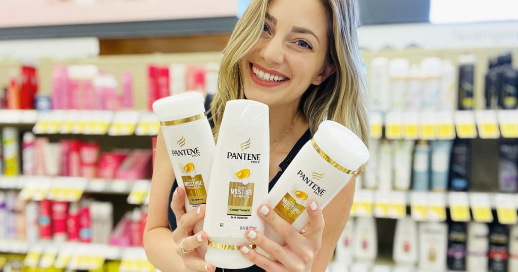 woman holding up 3 pantene products