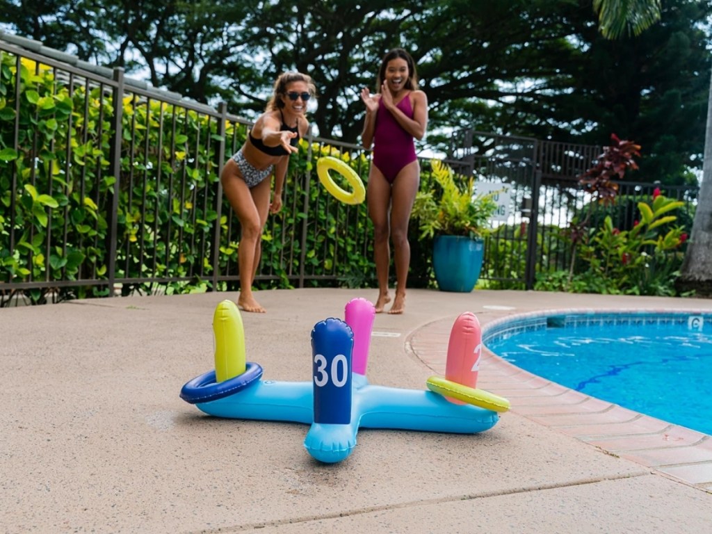 girls playing poolcandy inflatable ring toss by pool