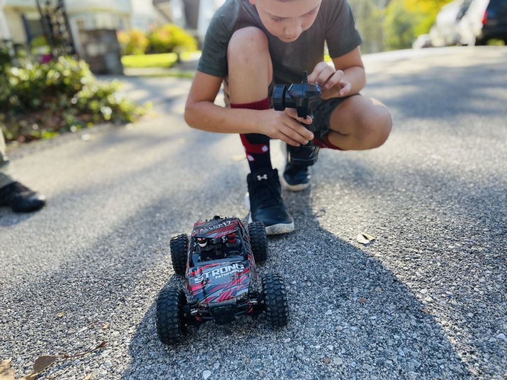 boy holding remote to RC truck