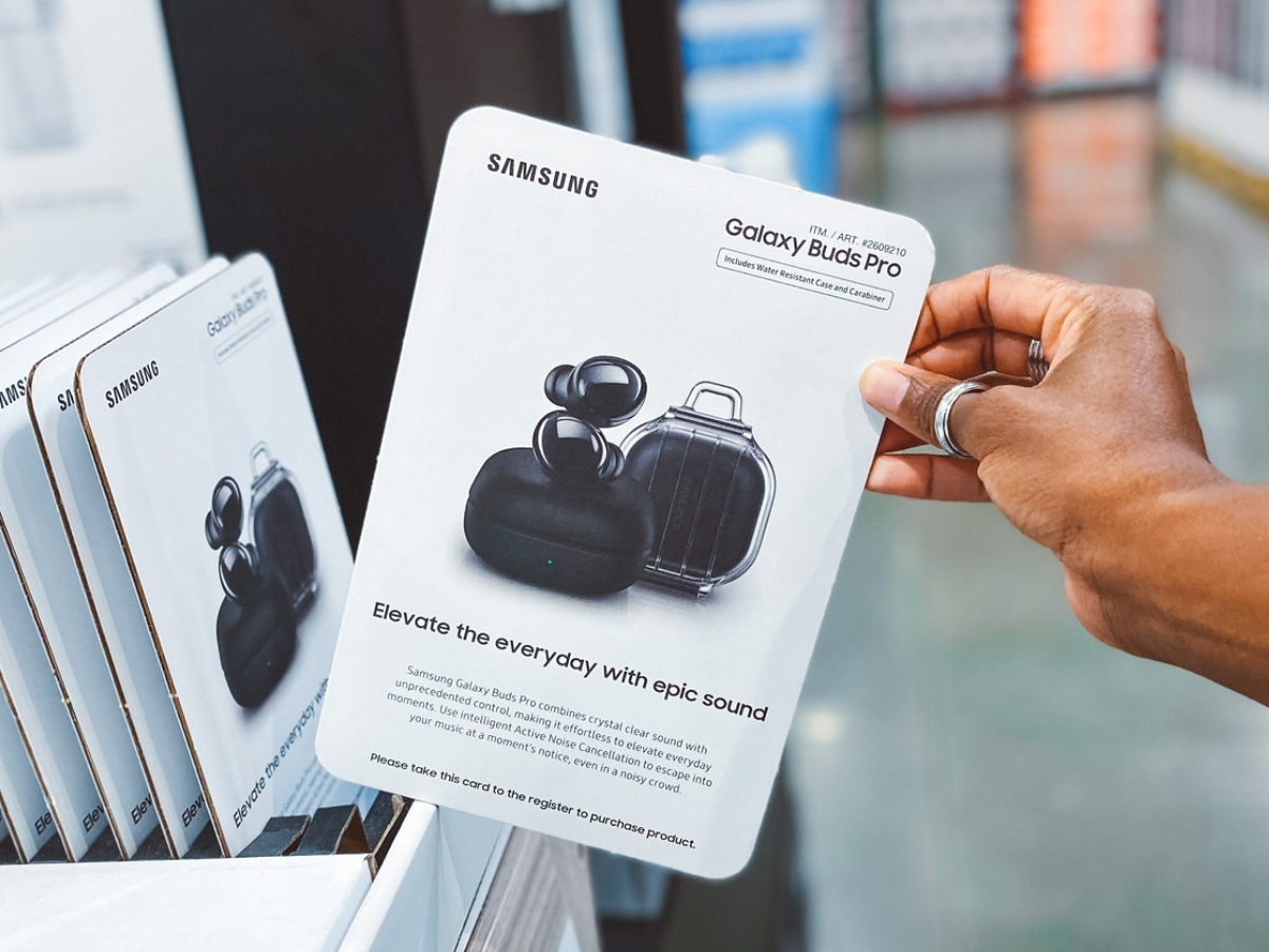 hand holding samsung galaxy buds pro in packaging