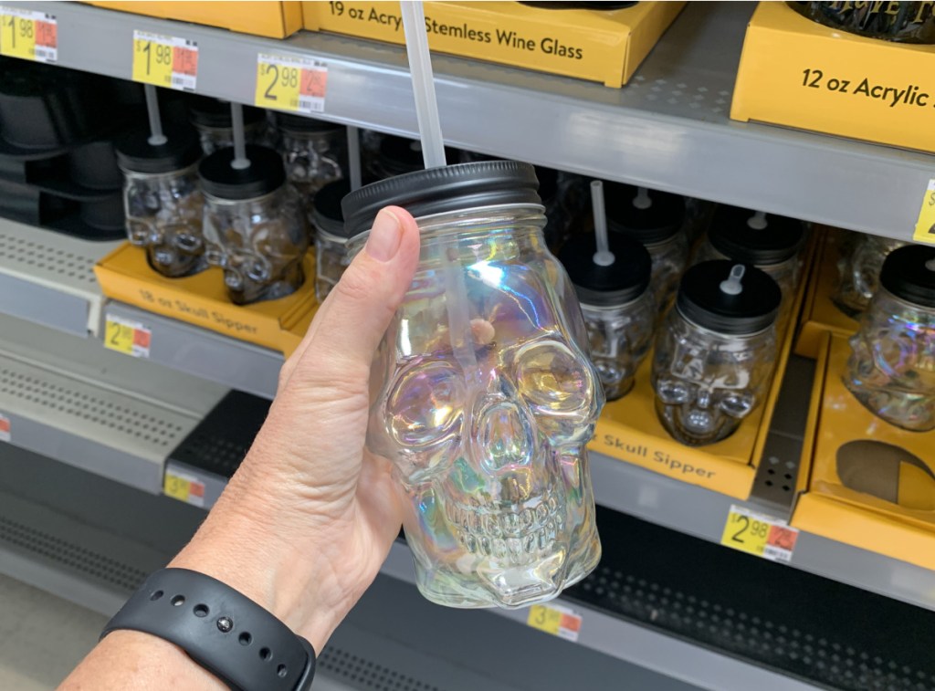 skull themed glass with straw in hand