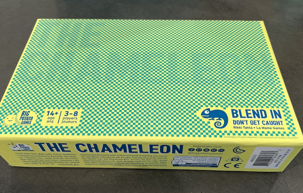 the chameleon game box on table