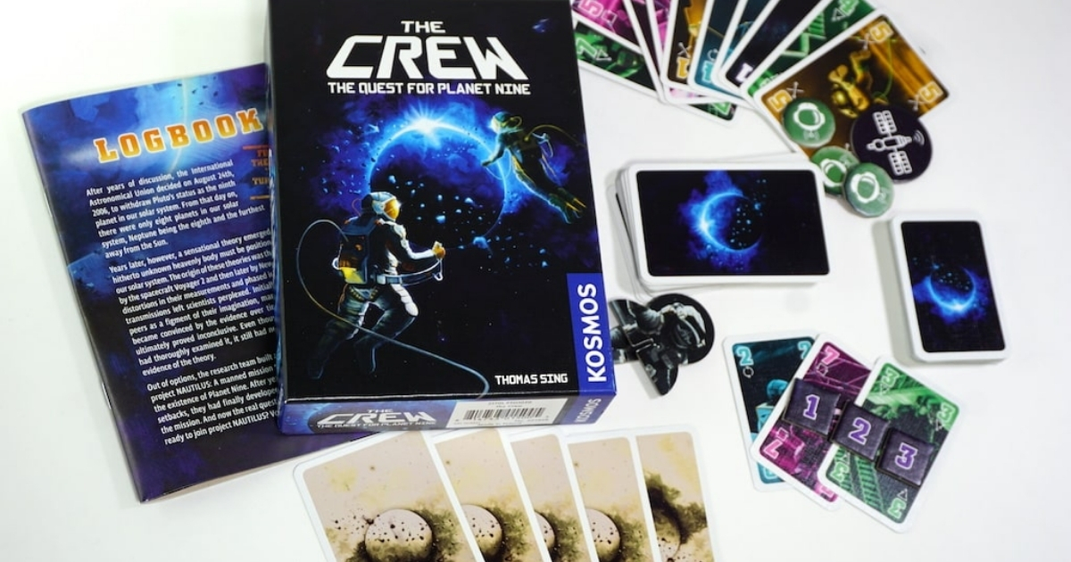 the crew the quest for planet nine card game with cards and pieces outside box