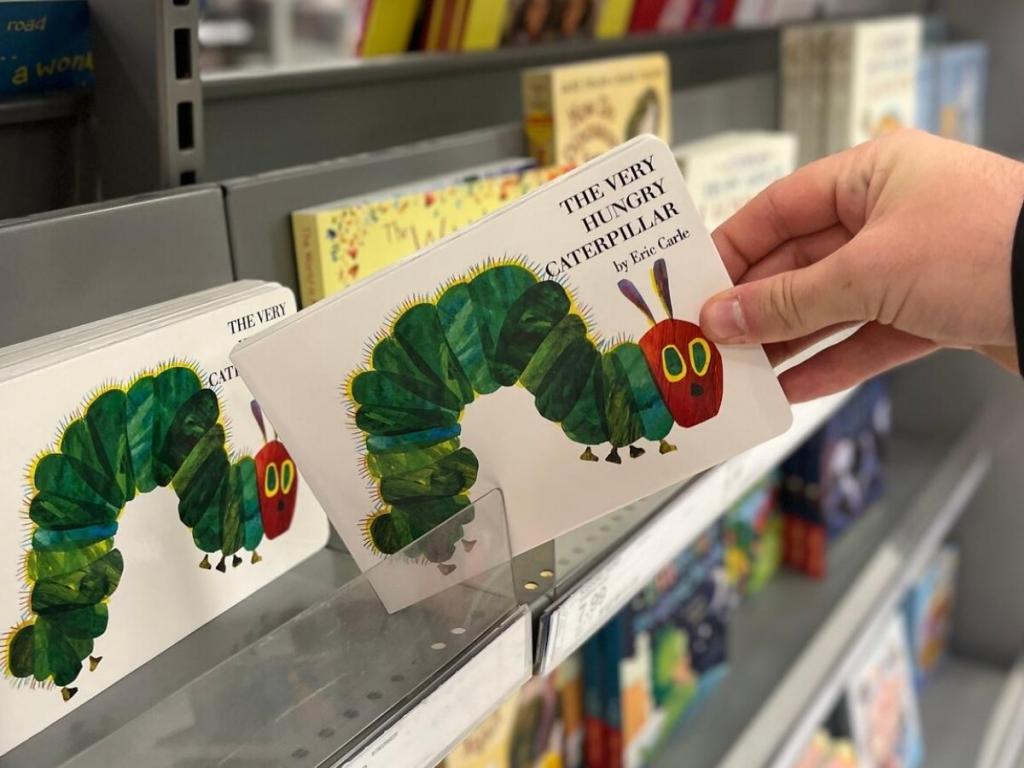 hand holding the very hungry caterpillar book in store