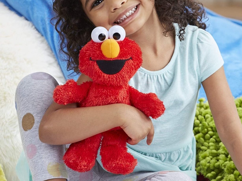 little girl with tickle me elmo toy