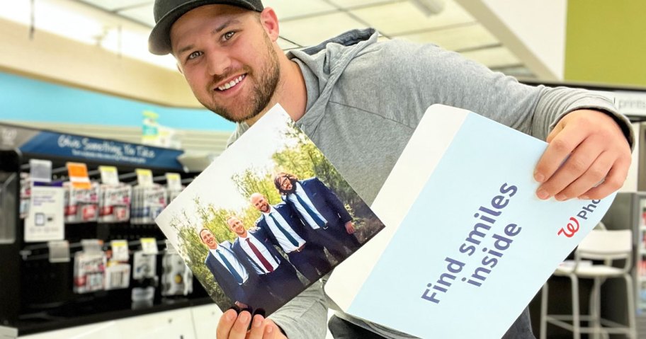 man inside walgreens holding 8x10 photo print