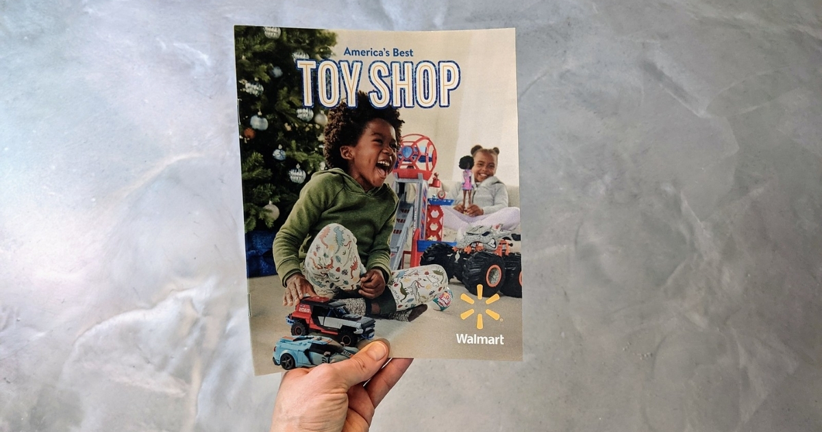 hand holding walmart holiday toy book for 2021