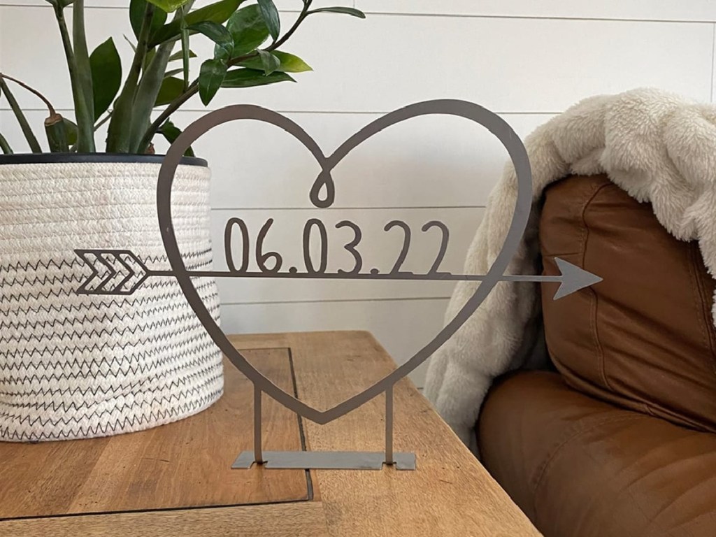 metal heart sign standing on side table