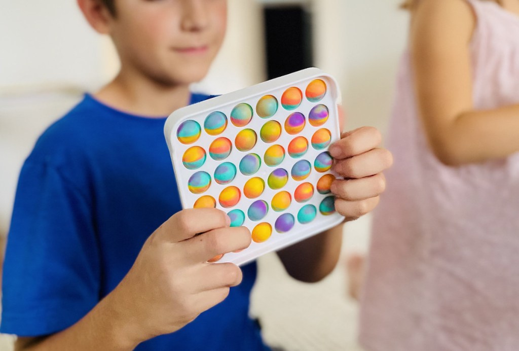 boy holding tie dye pop it toy 