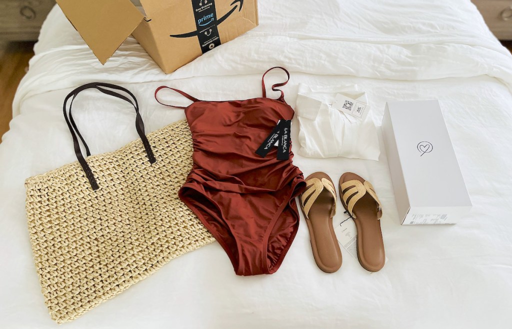 bathing suit outfit with sandals and beach bag laying on bed