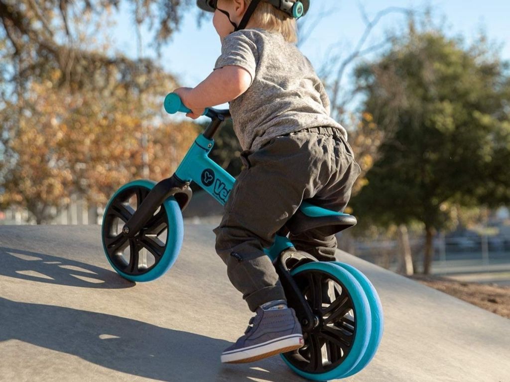 toddler riding blue balance bike