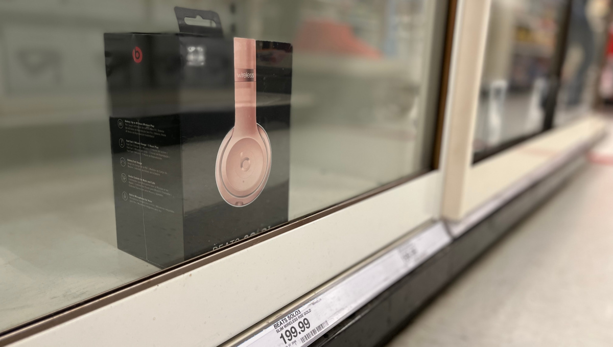package of beats solo three headphones behind a glass case