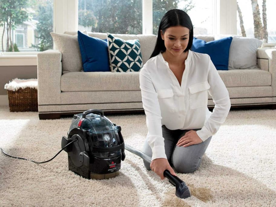 woman using Bissell SpotClean vacuum