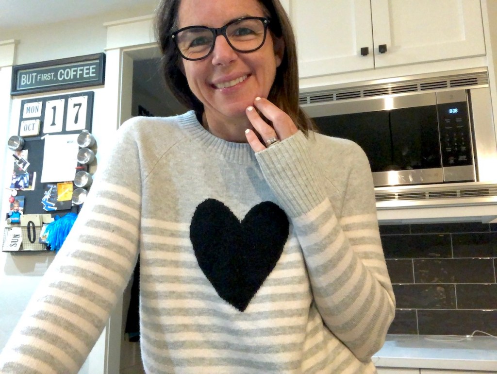 woman wearing heart stripe sweater in kitchen