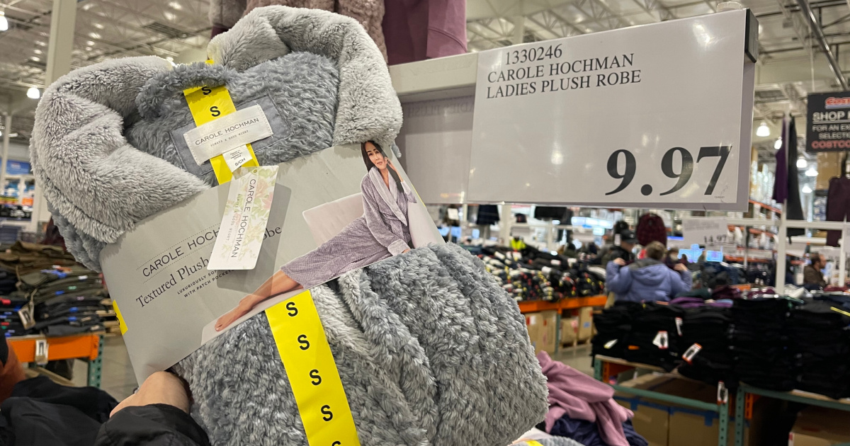 woman holding up a robe in costco