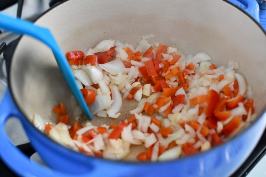 cooking onions and a bell pepper in dutch oven